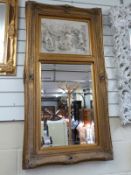 A gilt framed mirror with carved plaque dated 1892