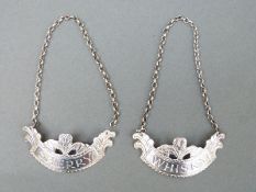 A pair of Georgian style hallmarked silver bottle tickets, one sherry the other whisky,