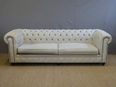A large upholstered Chesterfield sofa,