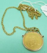 A 9ct gold pendant set with an Arabic coin on a 9ct gold chain,