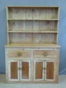 A pine dresser with plate rack above,