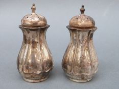 A pair of Edward VII hallmarked silver peppers, Sheffield 1904, maker Atkin Brothers, height 8cm,