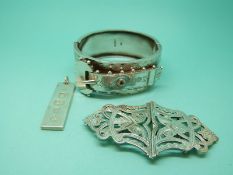 A Victorian silver bangle with chased foliate design,