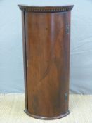 A small mahogany bow front corner cupboard,