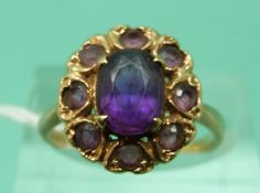 A 9ct gold ring set with amethysts in a cluster (size N/O)