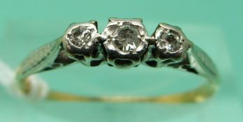 An 18ct gold ring set with three diamonds in a platinum setting (size P), weight 2.