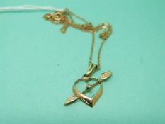 A 9ct gold chain and heart pendant set with a diamond
