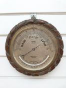 A John Barker Kensington oak rope twist barometer with curved thermometer below,