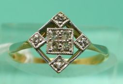 A yellow metal ring set with diamonds in a diamond shaped setting (size K)