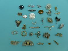 A collection of various vintage brooches to include mother of pearl violin, paste, abalone shell,