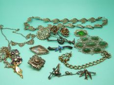 A collection of silver brooches including Victorian examples and two silver necklaces set with