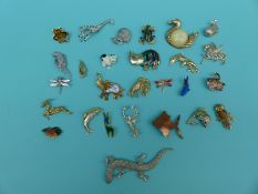 A collection of animal brooches including a large lizard, sheep, hippo, scorpion,