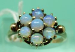 A 9ct gold ring set with a cluster of opals (size L)