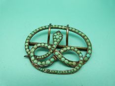 A Victorian buckle in the form of a snake set with turquoise cabochons,