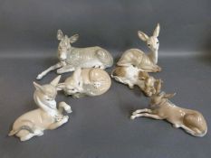 A collection of Lladro animal figures including donkeys, fox, deer,