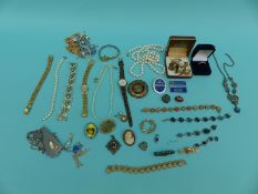 A collection of costume jewellery including a 9ct gold brooch, silver brooch,