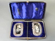 A cased pair of 19thC cut steel buckles