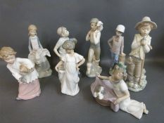 A collection of Nao child figures including boy with puppy, girl with goose,
