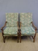 A pair of throne armchairs with carved arms and stretchers