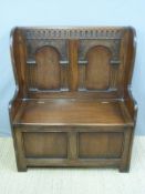 An oak monk's bench with lift up seat (W86 x D40 x H104cm)