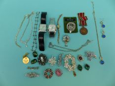 A collection of costume jewellery to include brooches, necklaces,