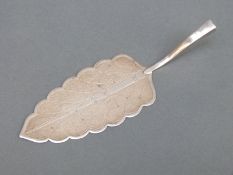 A likely Islamic/middle eastern white metal cake slice formed as a leaf, length 18cm,