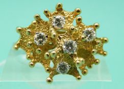 An 18ct gold ring set with five diamonds in an abstract setting, in Garrard and Co box (size L),