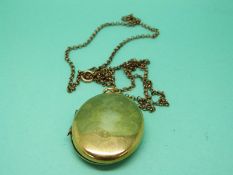 A yellow metal locket on a 9ct gold chain (21.