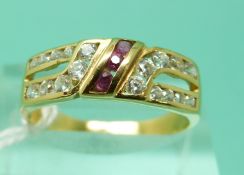 An 18ct gold ring set with rubies and cubic zirconia with French eagle mark (size O), weight 2.