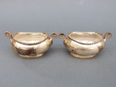A pair of Victorian boat-shaped hallmarked silver salts with clear glass liners, Sheffield 1894,