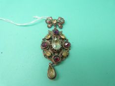 A white metal brooch set with foiled gemstones