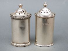 Two George V hallmarked silver peppers, Sheffield 1918 and 1933, maker Atkin Brothers, height 6.