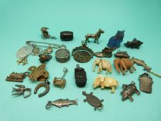 A collection of charms etc including stanhopes and silver