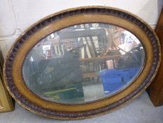 An oval bevelled edge mirror (W90cm)