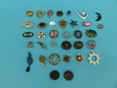 A collection of brooches including paste set, enamel, mother-of-pearl, wood, Austrian,