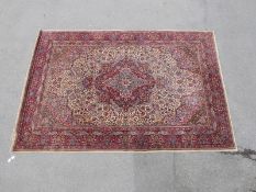 A large Indian carpet beige ground,