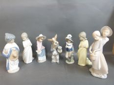 Nao figures including dog in morning dress, Spanish girl, boy and girl,