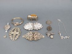 A hallmarked silver buckle, plated and white metal items including an elephant pin cushion,