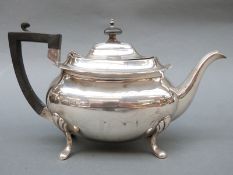 A George V Walker & Hall hallmarked silver teapot raised on four splayed legs, Sheffield 1929,