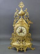A French gilt matel clock with two train movement striking on a bell, with key,