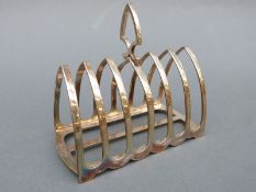 A George V hallmarked silver six slice toast rack, London 1908 maker Charles & George Asprey, 12.
