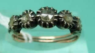 A Georgian / Victorian yellow metal ring set with rose cut diamonds in a silver setting (size P)