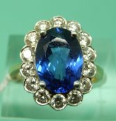 An 18ct gold ring set with a 3.5ct tanzanite surrounded by round cut diamonds measuring approx 0.