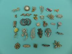A collection of brooches to include paste and marcasite set, also includes a 1971 'sphinx' deer no.