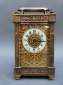 Edwardian brass carriage clock with pierced galleried and fretworked decoration,