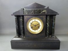 A late 19thC black slate mantel clock in classical architecture style inset with marbled decoration
