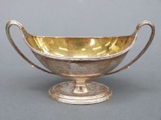 George III hallmarked silver table salt of pedestal form with sweeping handles and gilt interior,