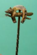 A stick pin with a fox and horseshoe finial marked 14ct gold in original box