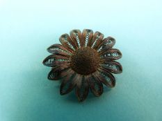 A white metal filigree necklace made up of layered floral links,