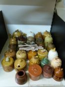 A collection of over twnety ceramic honey pots etc
